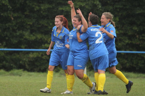Sam Wood is mobbed by her teammates after scoring a stunning free kick